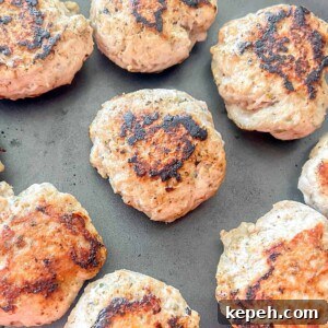 Turkey sausage patties in a pan after cooking.