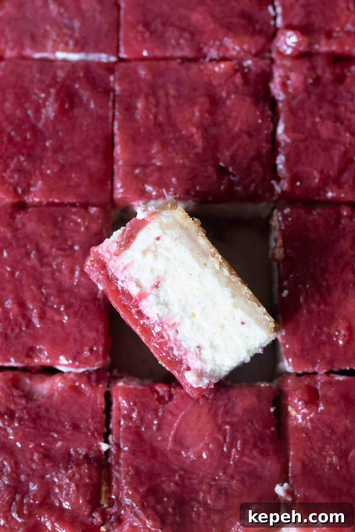 Strawberry Cheesecake Bar Recipe: Creamy No-Bake Dessert Bars 8 A cheesecake bar side shot of the bar surrounded by the rest of the strawberry topping.