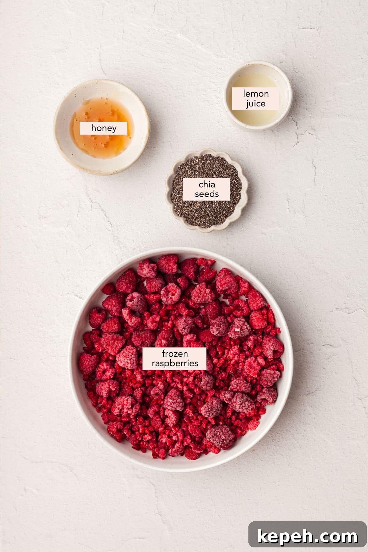 Ingredients: raspberries, lemon juice, chia seeds, honey. Labeled ingredients for raspberry chia jam.