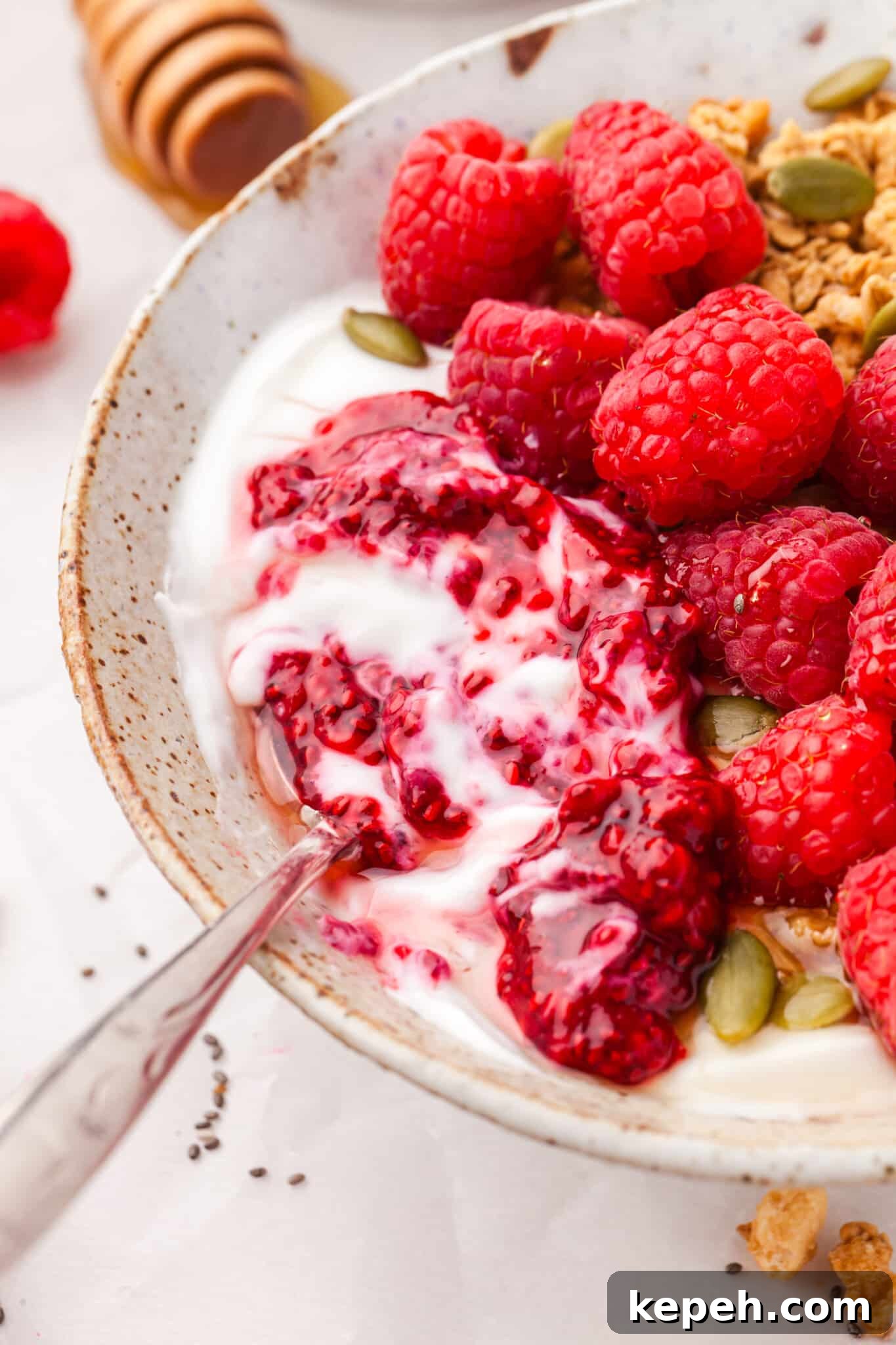 Raspberry Chia Seed Jam Recipe: Quick No-Cook Fruit Spread 8 Raspberry chia seed jam in a bowl of yogurt and granola.