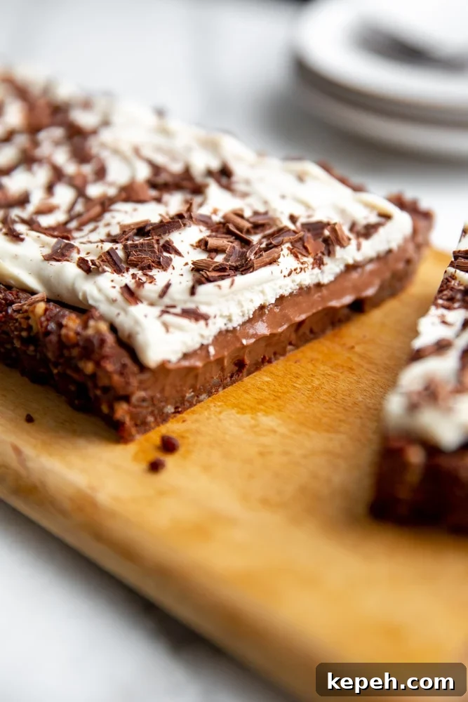Close up of the inside of the chocolate pudding tart on a wooden serving board.