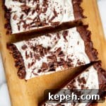Vegan chocolate tart on a wood serving board.