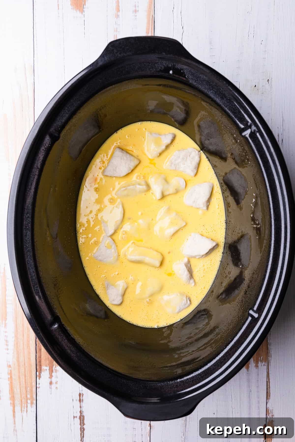 Crockpot Biscuits and Sausage Gravy Casserole 8 The beaten eggs added to the crockpot.