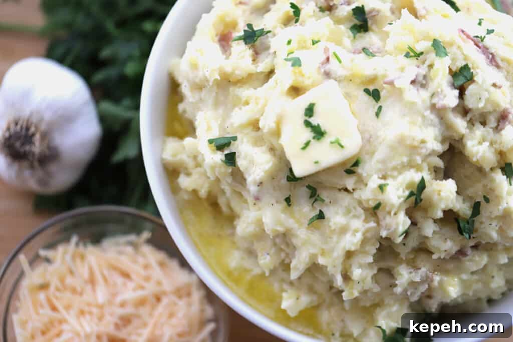 Garlic Parmesan Mashed Potatoes Recipe – Creamy, Savory Side Dish 3 Mashed potatoes garlic parmesan in a bowl topped with butter.