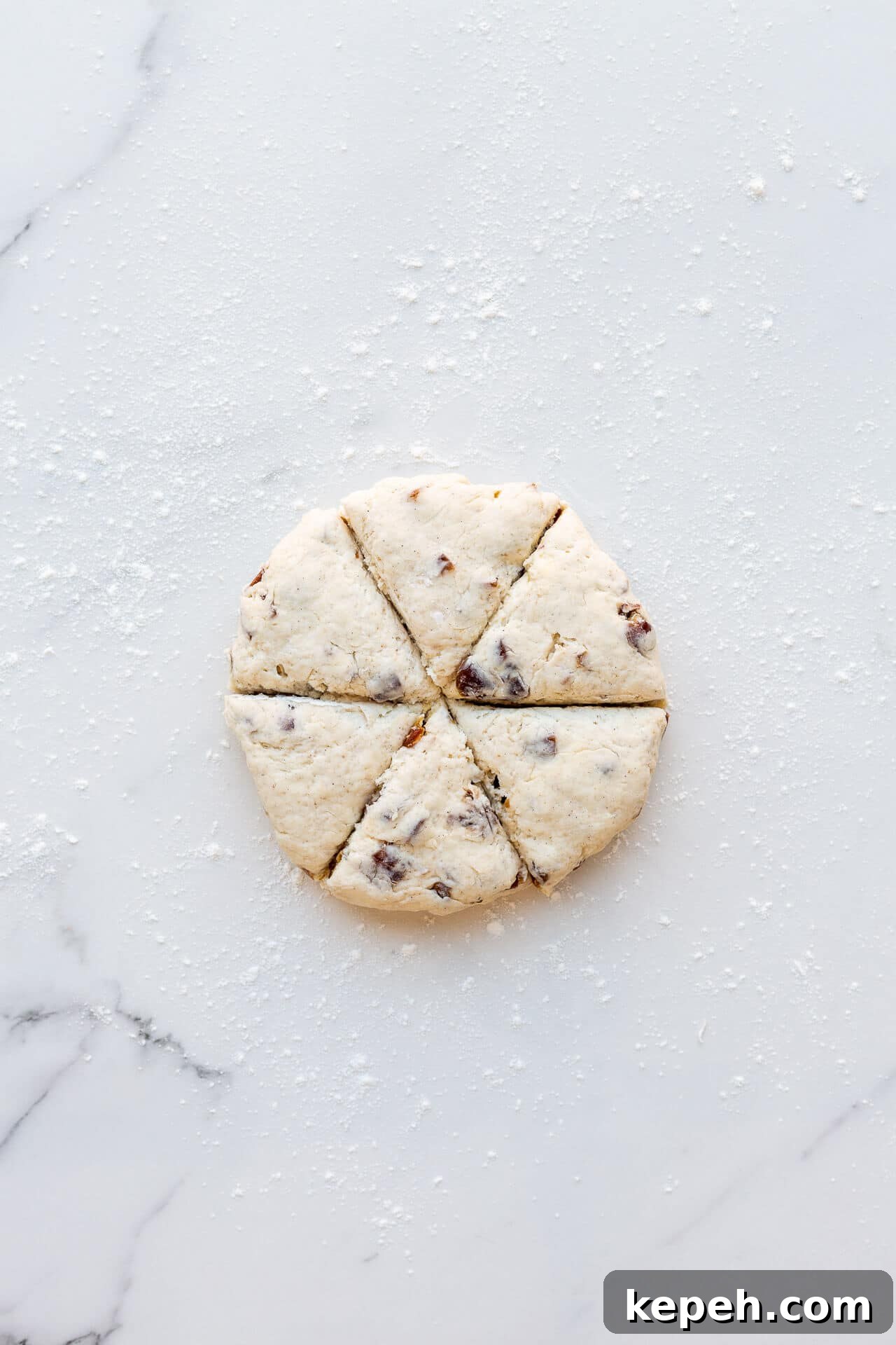 Chewy Date Scones with Honey Glaze 4 Cutting fruit scones into wedges from a disk of date scone dough