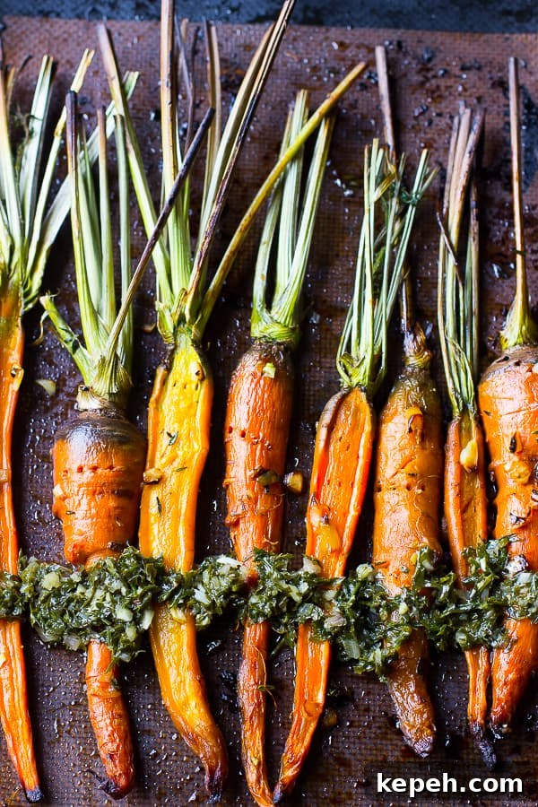 Overhead view of roasted carrots on a baking sheet. 