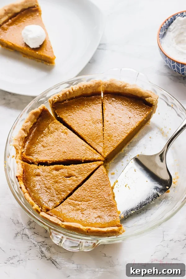 Slices of pumpkin pie on a glass dish. 