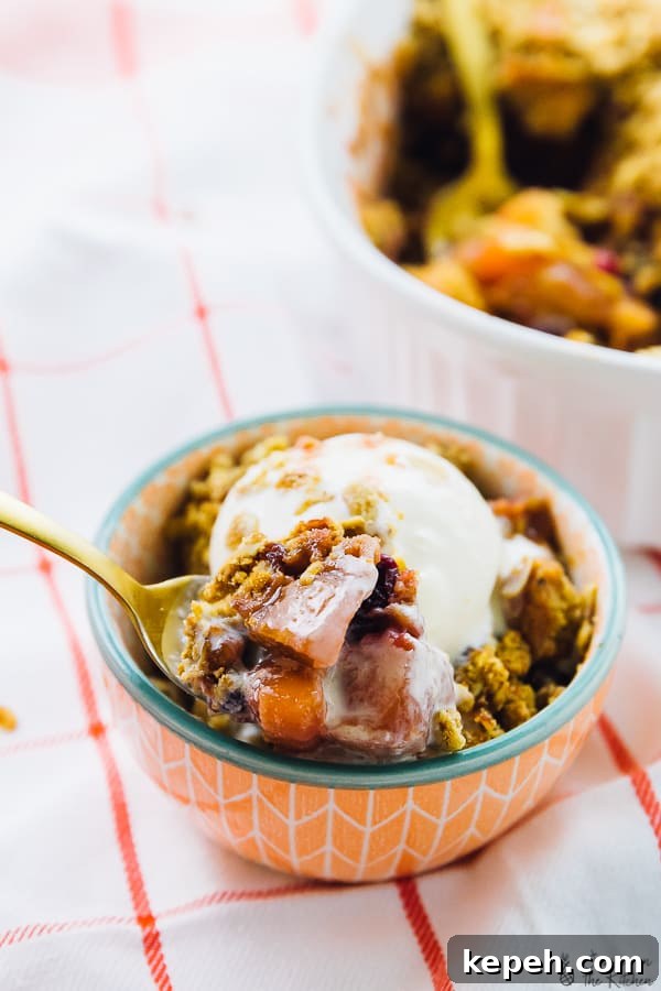 Cranberry apple crisp in an orange bowl. 