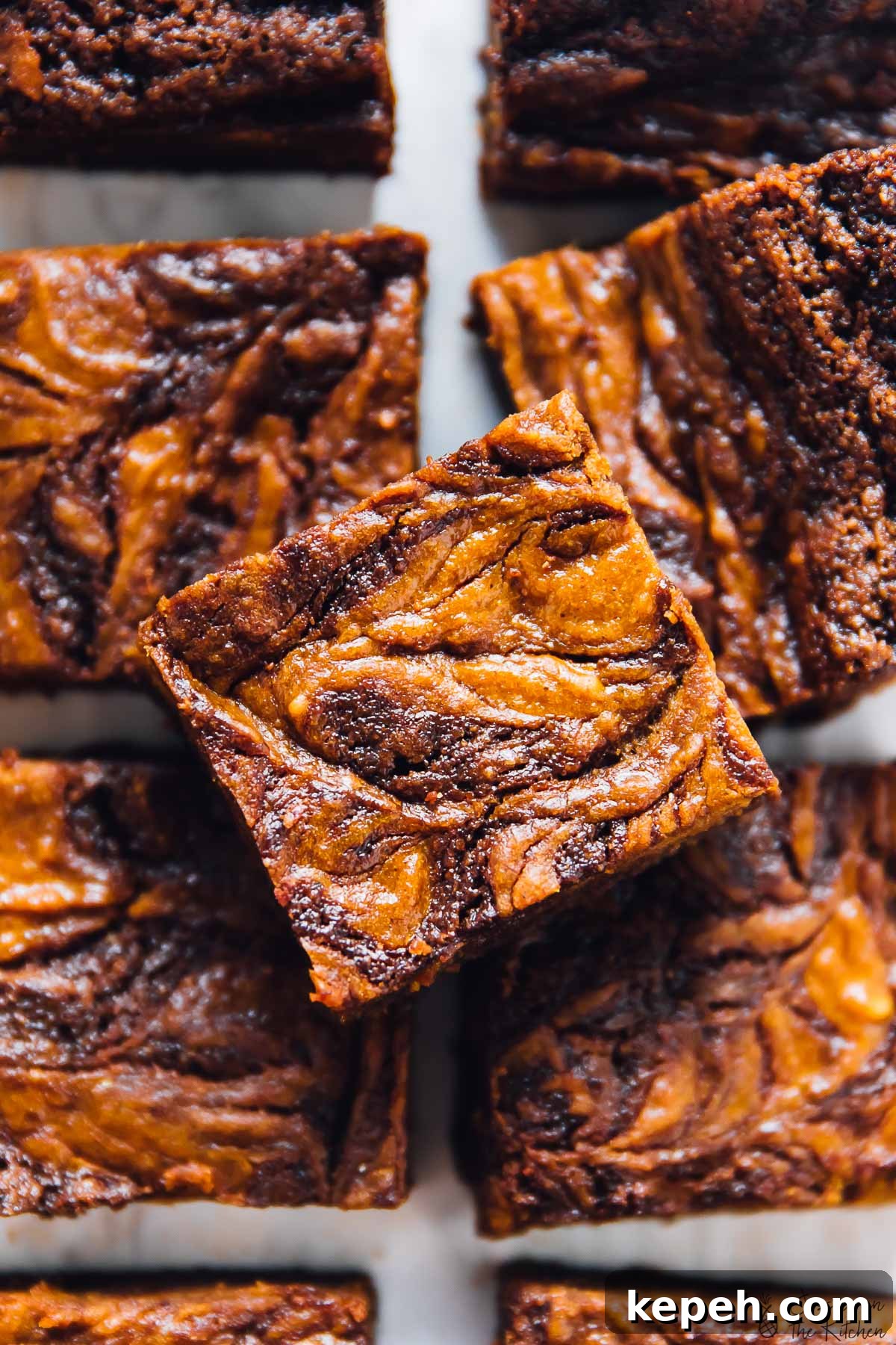 Overhead view of pumpkin cheesecake swirl brownies.