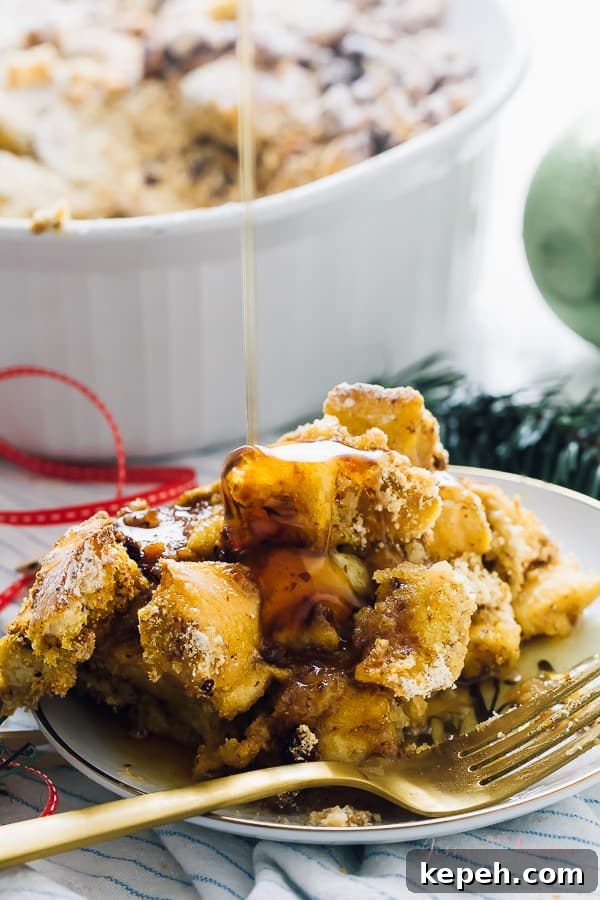A portion of french toast casserole being drizzled with syrup. 