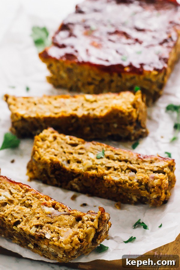 Vegan meatloaf, sliced, on parchment paper. 