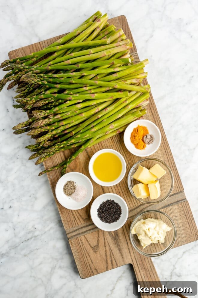 Roasted Asparagus with Lemon Cardamom Cream Sauce 3 All of the ingredients for roasted asparagus with lemon cardamom sauce on a wooden cutting board.