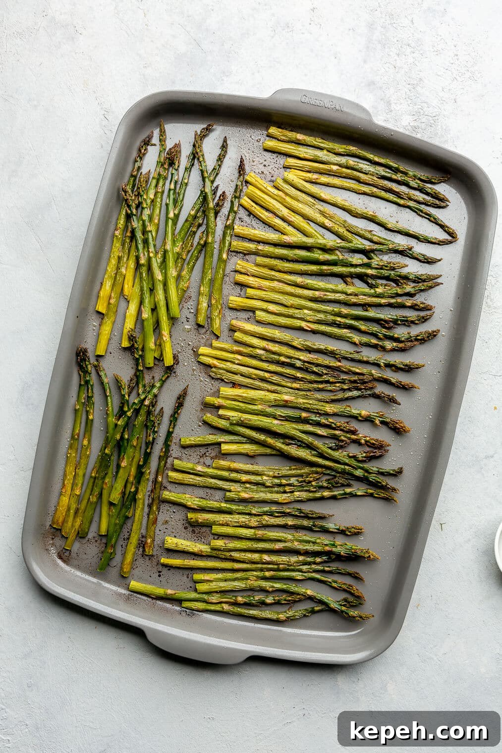 Roasted Asparagus with Lemon Cardamom Cream Sauce 8 A zoomed out top view of roasted asparagus on a sheet pan.