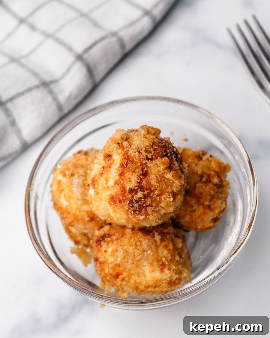 Air Fryer Crispy Carnivore Cream Cheese Bites with kitchen towel and fork