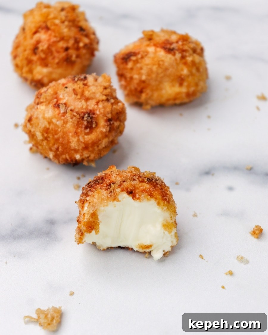 Air Fryer Crispy Carnivore Cream Cheese Bites with bite taken out separated view