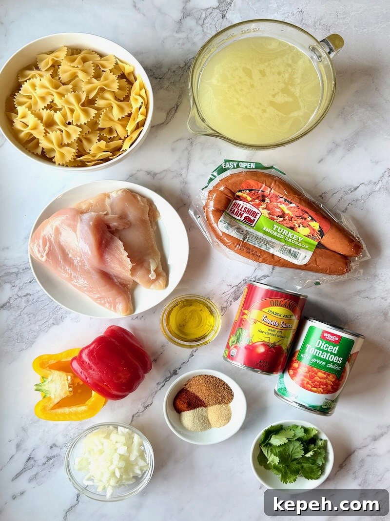 One-Pot Jambalaya Pasta Recipe: Quick Cajun-Style Meal 3 Ingredients displayed for one-pot jambalaya pasta. Bow tie pasta, chicken broth, chicken breast, smoked sausage, olive oil, tomato sauce, tomatoes and green chils, seasonings, onions, bell peppers, and cilantro.