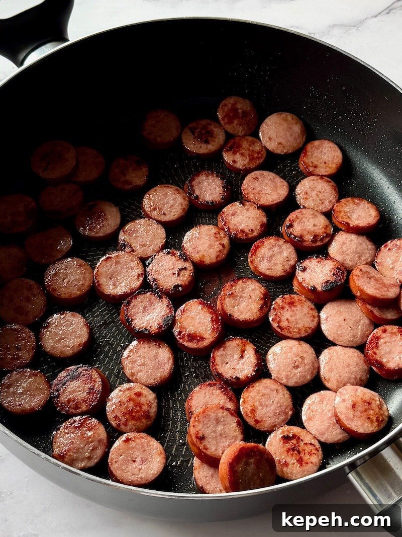 One-Pot Jambalaya Pasta Recipe: Quick Cajun-Style Meal 4 Smoked sausage slices browned in a large skillet.