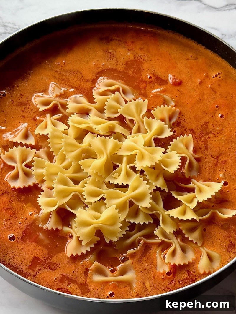 One-Pot Jambalaya Pasta Recipe: Quick Cajun-Style Meal 7 All the ingredients added to the skillet minus the cilantro.
