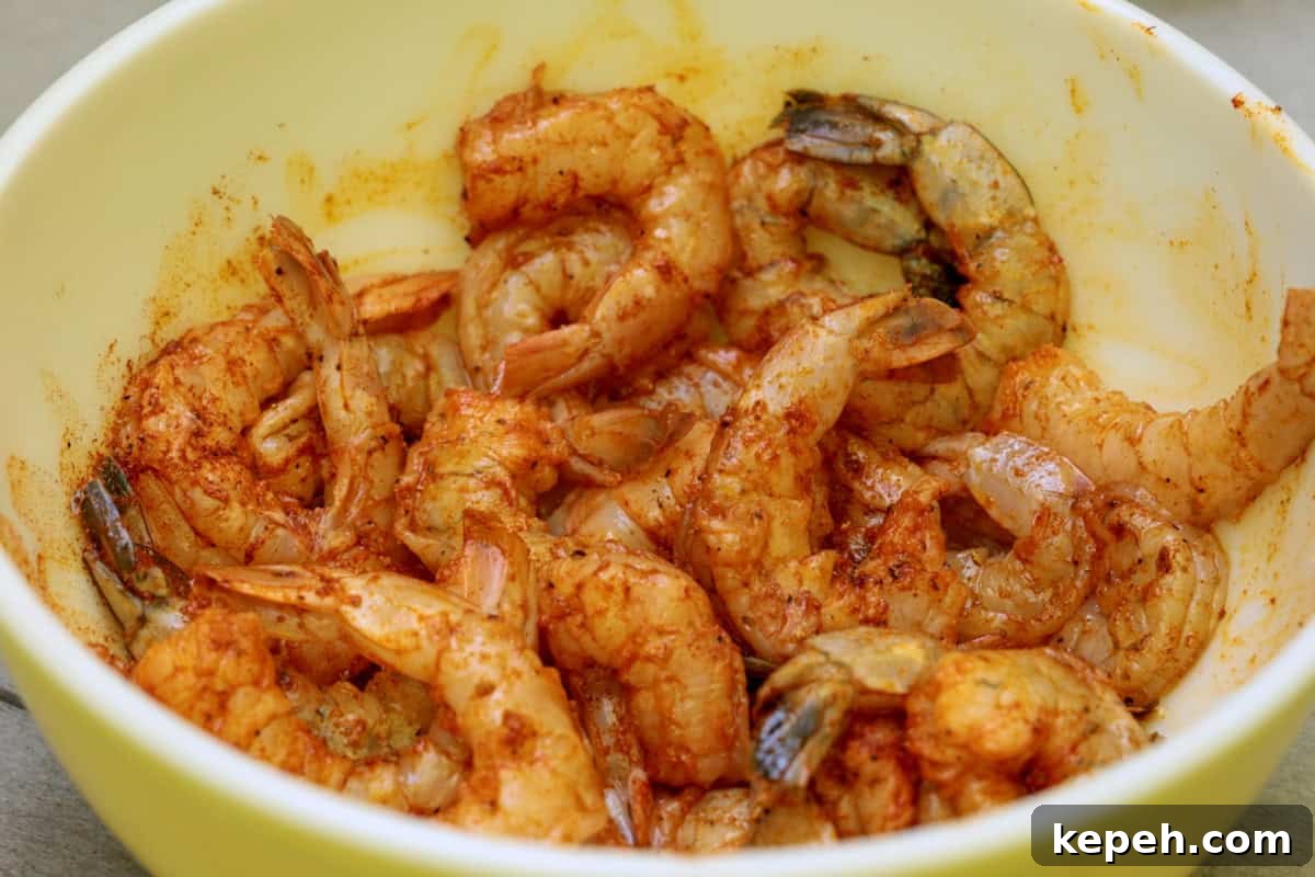 How to Smoke Shrimp Perfectly: Simple Steps for Juicy Flavor 7 Two dozen shrimp seasoned and marinating in a bowl.