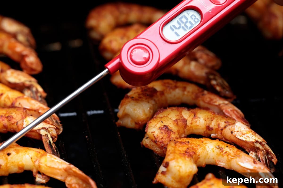 How to Smoke Shrimp Perfectly: Simple Steps for Juicy Flavor 10 Checking the temperature of shrimp on a grill with a meat thermometer.