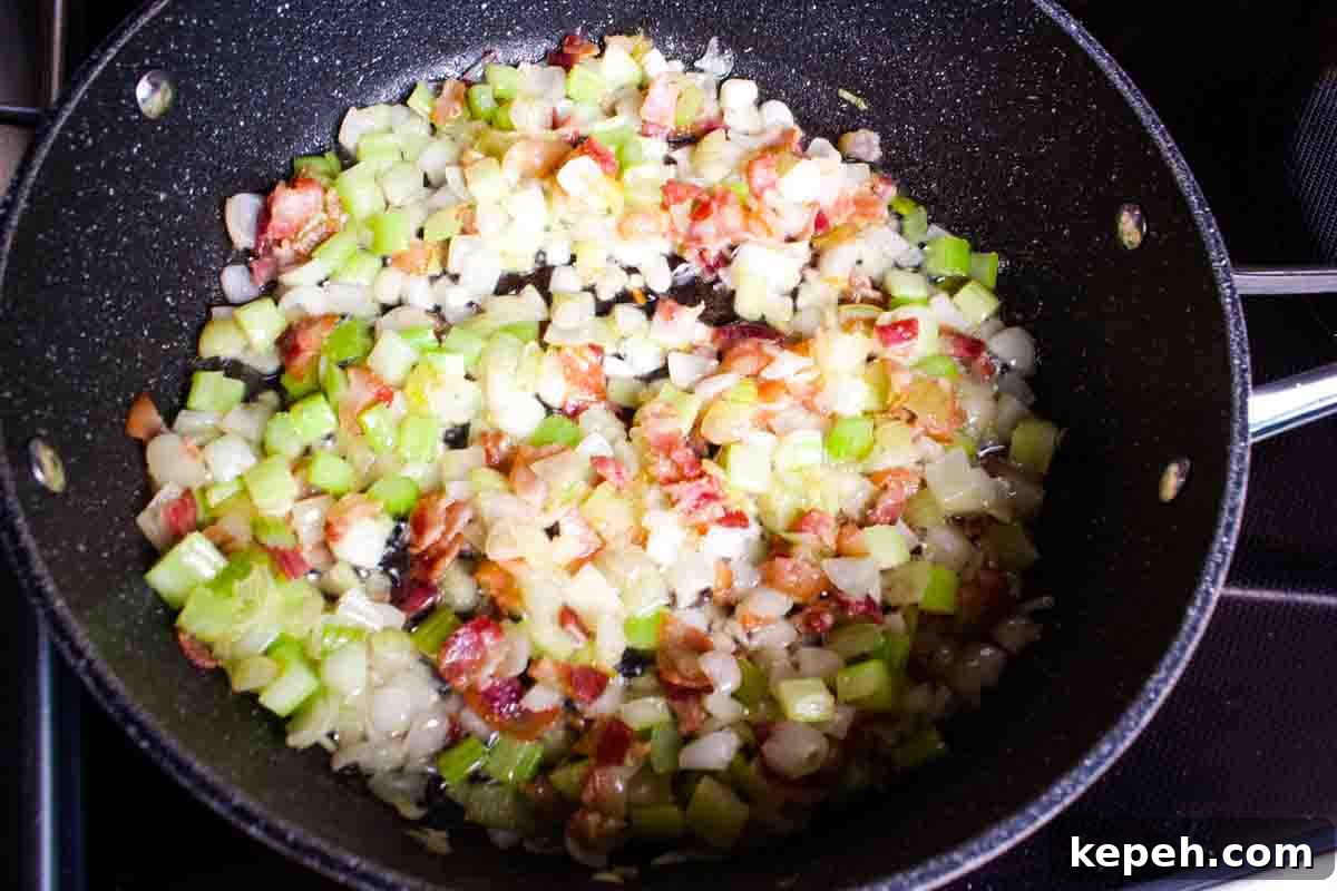 Bacon and Cranberry Stuffing Recipe for Holiday Tables 4 The onion and celery added to a large skillet with bacon.