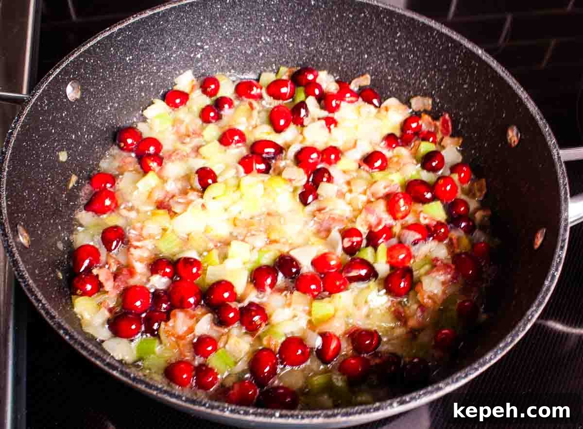 Bacon and Cranberry Stuffing Recipe for Holiday Tables 5 The cranberries and butter added to the large skillet.