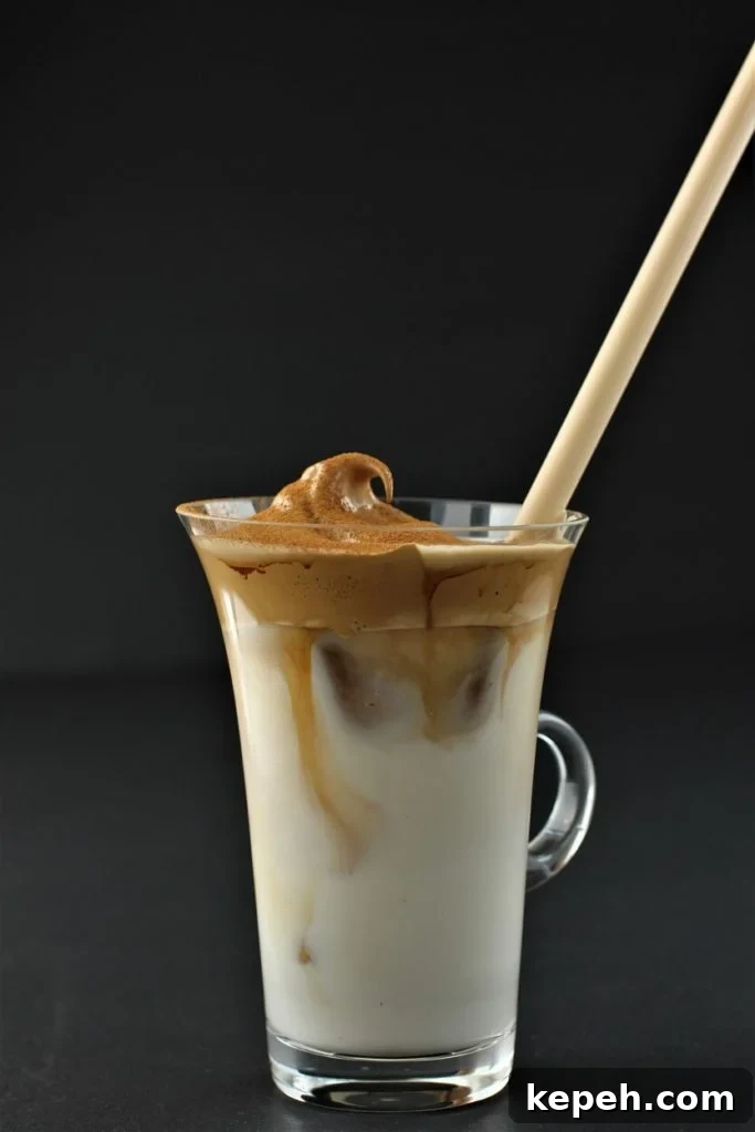 Dalgona Whipped Coffee Recipe: Creamy Instant Coffee at Home 2 the coffee starts to curl down into the milk