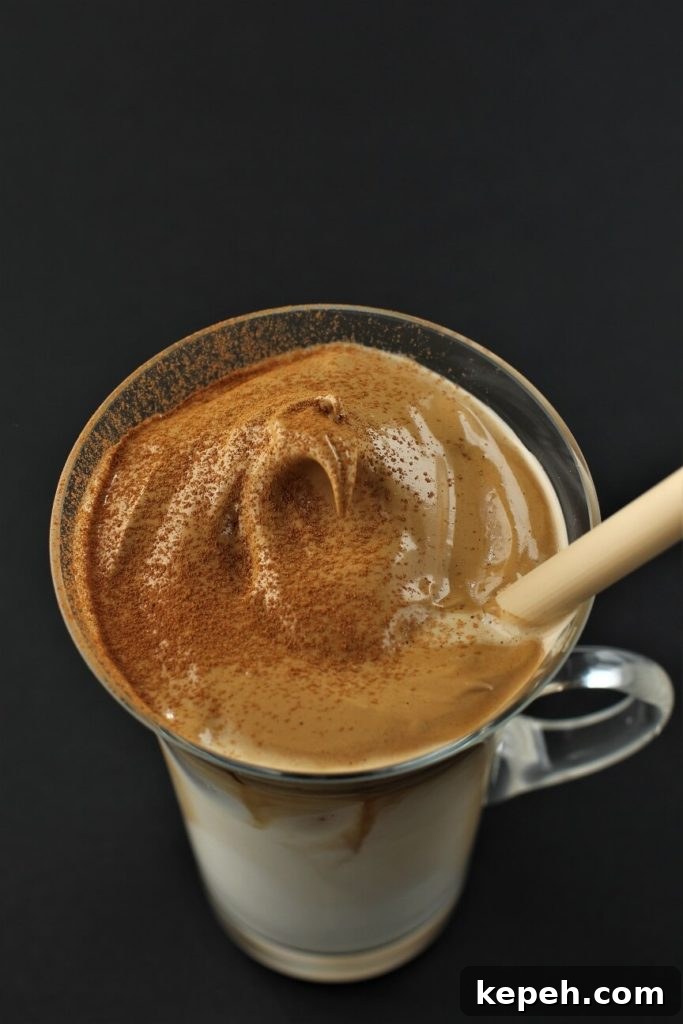 Dalgona Whipped Coffee Recipe: Creamy Instant Coffee at Home 8 tops view of the whipped dalgona coffee foam in the cup
