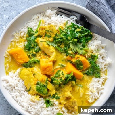 Creamy Coconut Milk Slow Cooker Chicken Recipe 6 coconut milk chicken over rice with fork