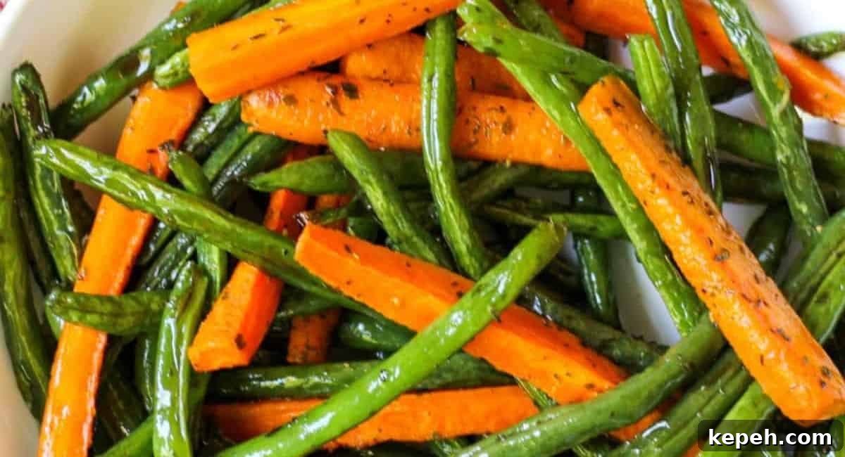 Overhead image of roasted green beans and carrots.