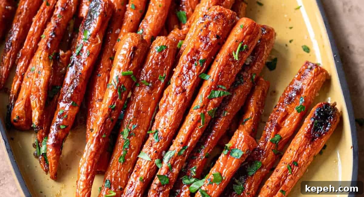 Overhead image of maple roasted carrots on yellow dish.