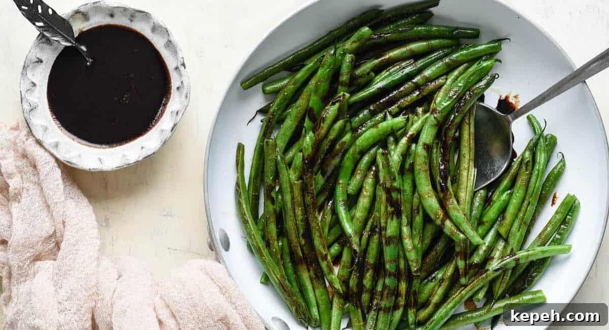 An overhead image of balsamic green beans on white dish.