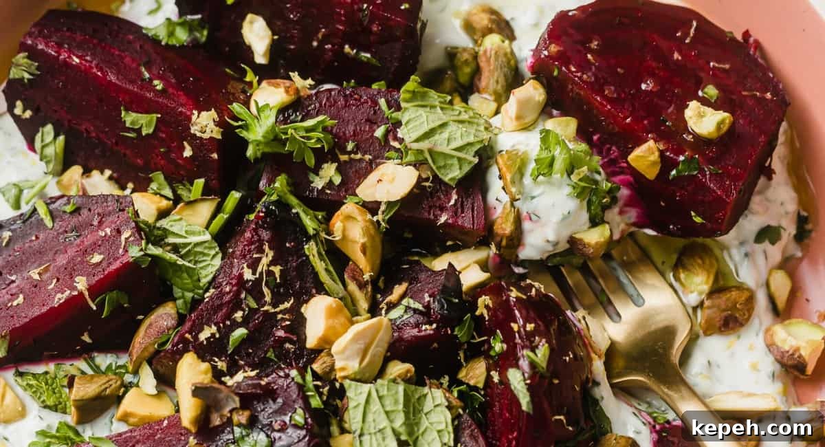 Up close image of roasted beets with herby skyr and pistachios.