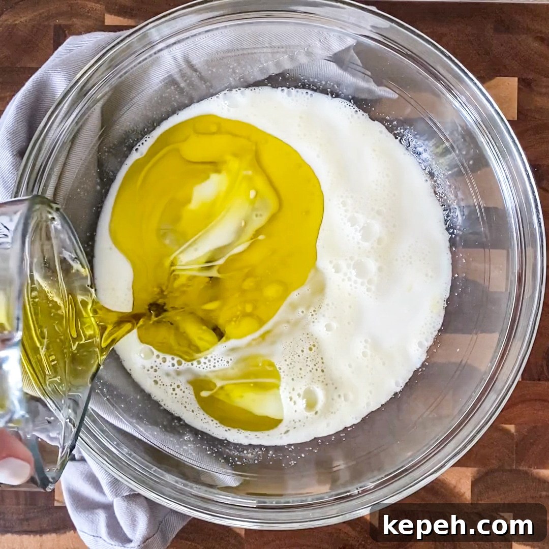 Italian Lemon Olive Oil Cake with Fresh Blackberries 6 adding oil to cake batter
