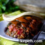 Summer Dinner Ideas: Weeknight Meal Plan for Hot Evenings 4 A stuffed poblano pepper with enchilada sauce.