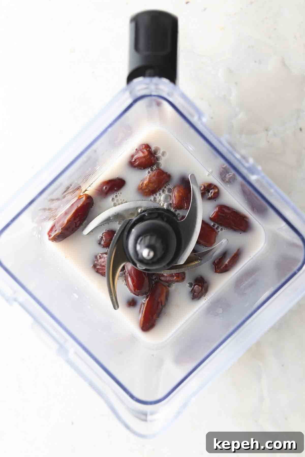 Creamy Vegan Fruit Dip Recipe for Parties and Snacks 4 Dates, coconut milk, maple syrup and salt in a food processor.