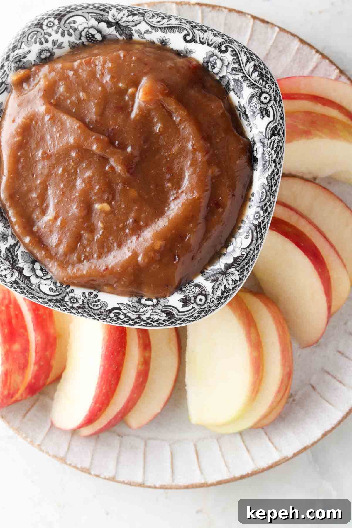Creamy Vegan Fruit Dip Recipe for Parties and Snacks 6 Fruit dip in a black and white bowl with apple slices on the side.