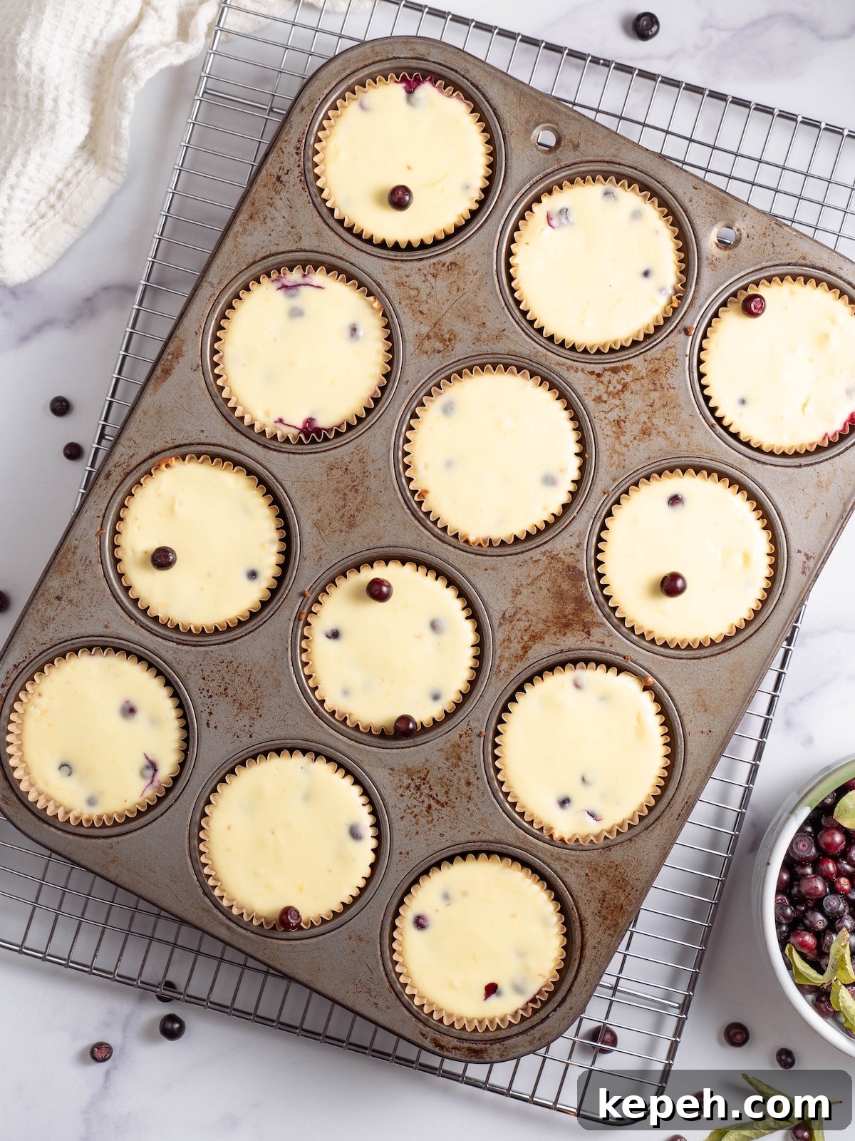 Mini Huckleberry Cheesecake Bites: Tangy Dessert Recipes 6 Miniature huckleberry cheesecakes after baking