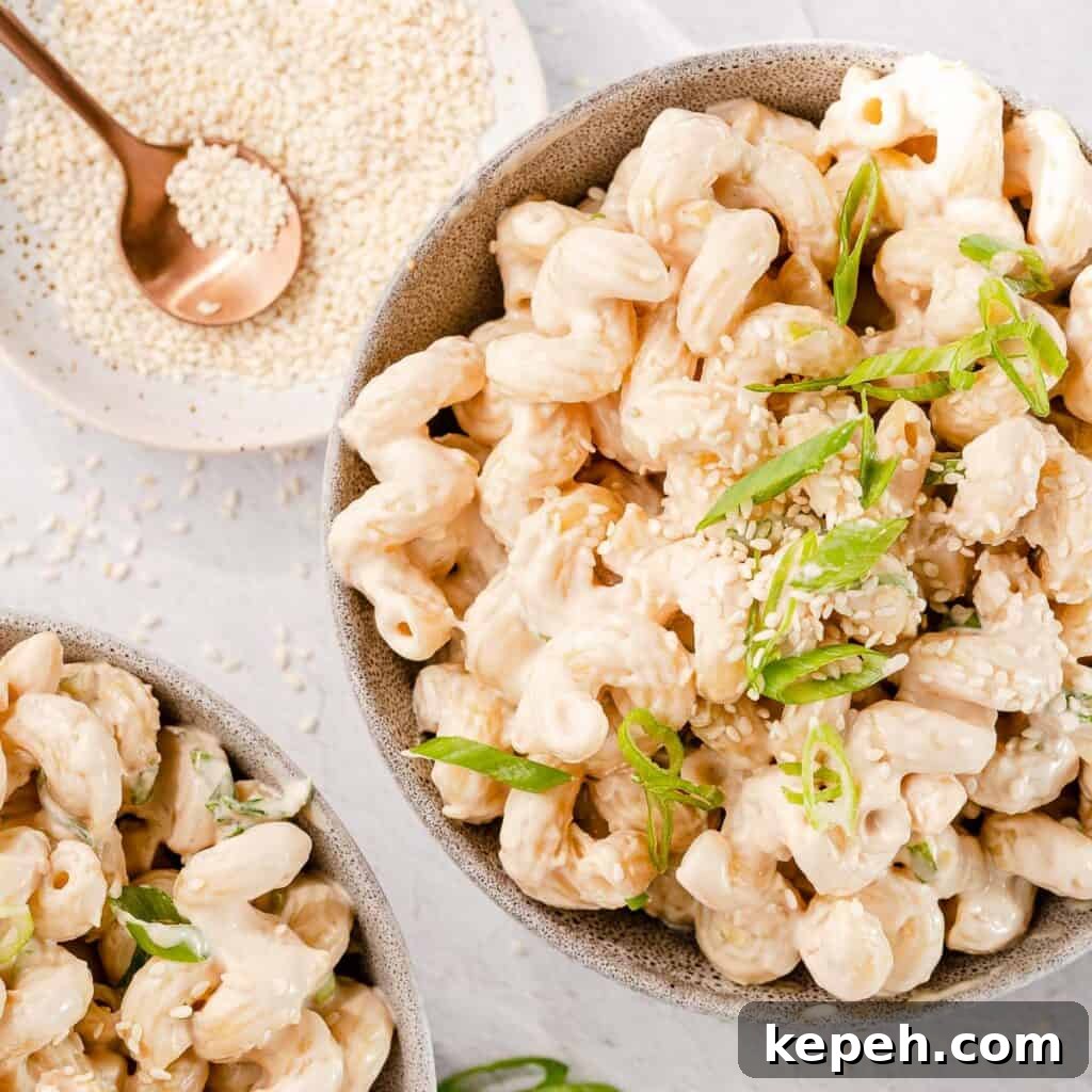 tahini pasta in two bowls with sesame seeds on the side