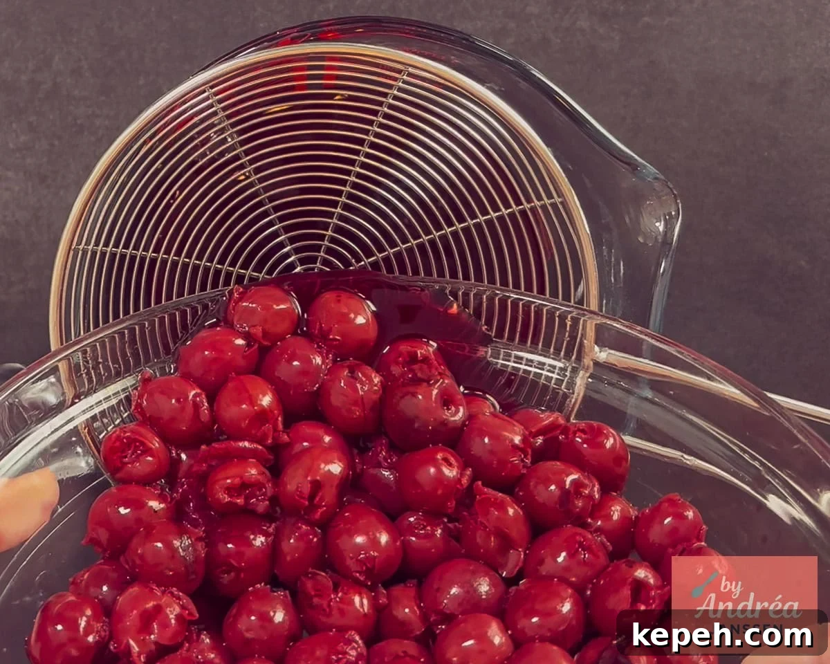 A jar of cherries is placed in a sieve.