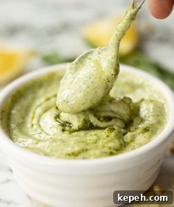 Pesto Mayonnaise teaspoon dunking into pesto mayo