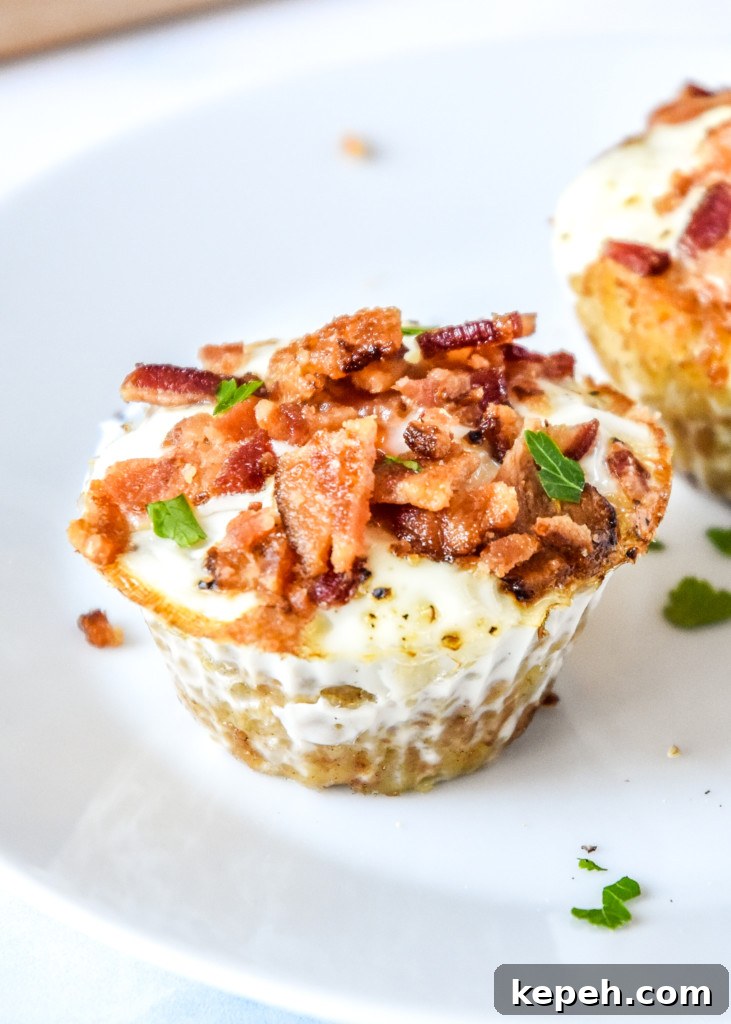 Tater Tot Crust Baked Egg Cups: Crispy Potato Breakfast Cups 11 tater tot crust baked egg cup on a plate viewed from the side.