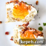 Tater Tot Crust Baked Egg Cups: Crispy Potato Breakfast Cups 17 tater tot crust baked egg cups cut in half on a white plate.