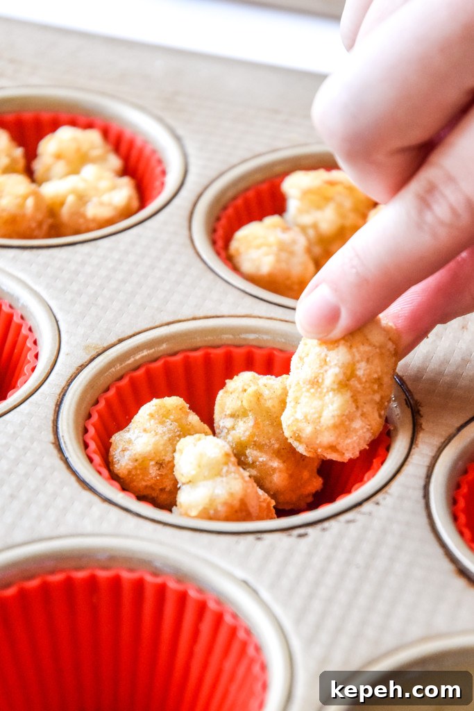 Tater Tot Crust Baked Egg Cups: Crispy Potato Breakfast Cups 5 adding tater tots to the muffin pan.