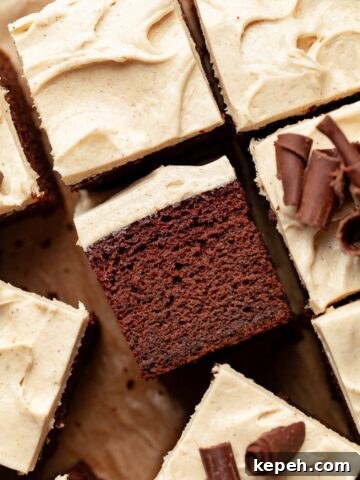 Gluten Free Spiced Chocolate Pumpkin Cake topped with spiced cream cheese frosting and chocolate curls