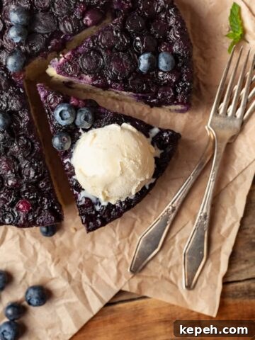 Gluten Free Blueberry Upside Down Cake topped with a scoop of vanilla ice cream
