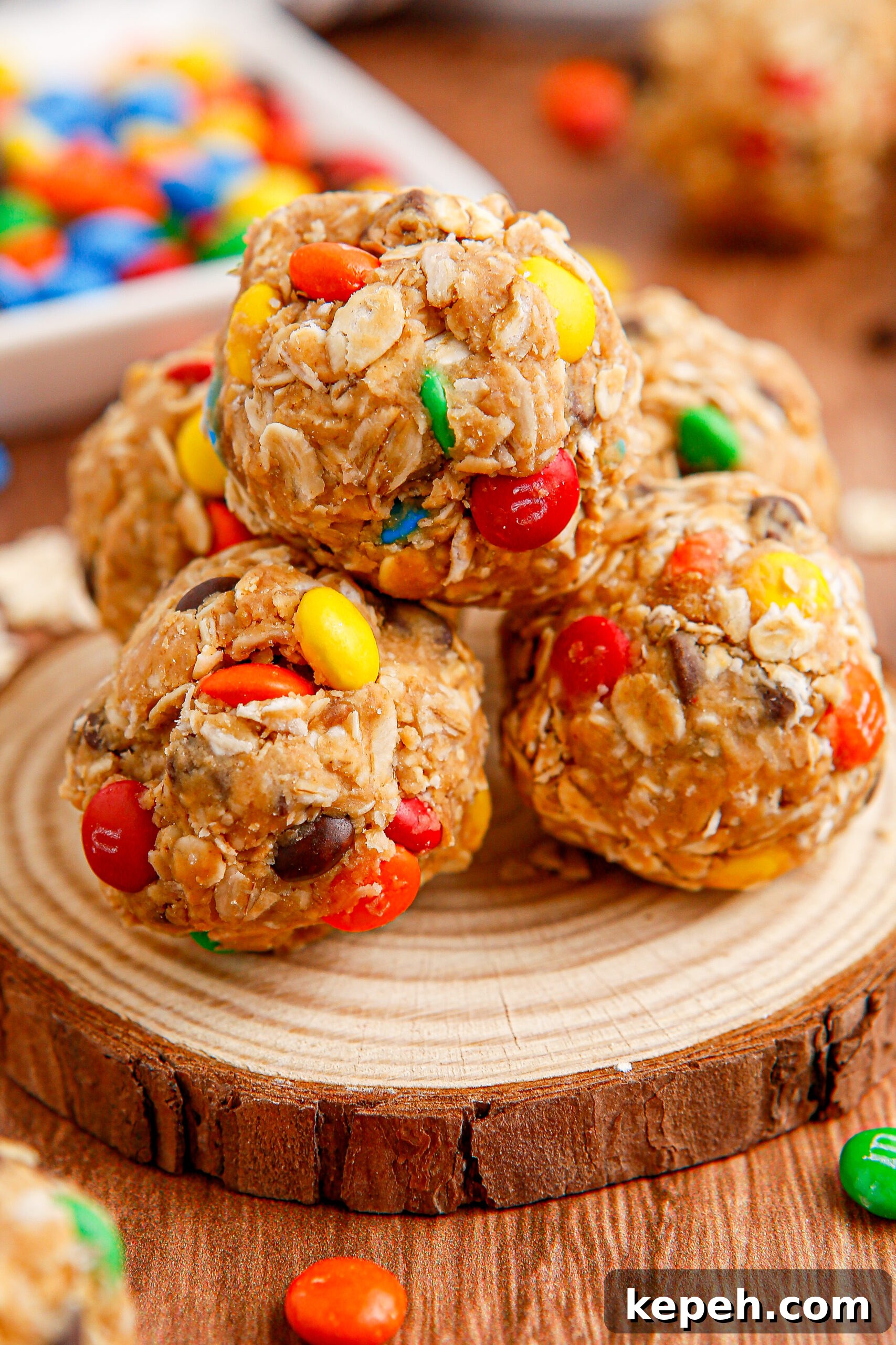 No-Bake M&M Energy Bites: Chocolate Peanut Butter Snack Balls 2 Close up view of No Bake M&M Energy balls on a wooden table