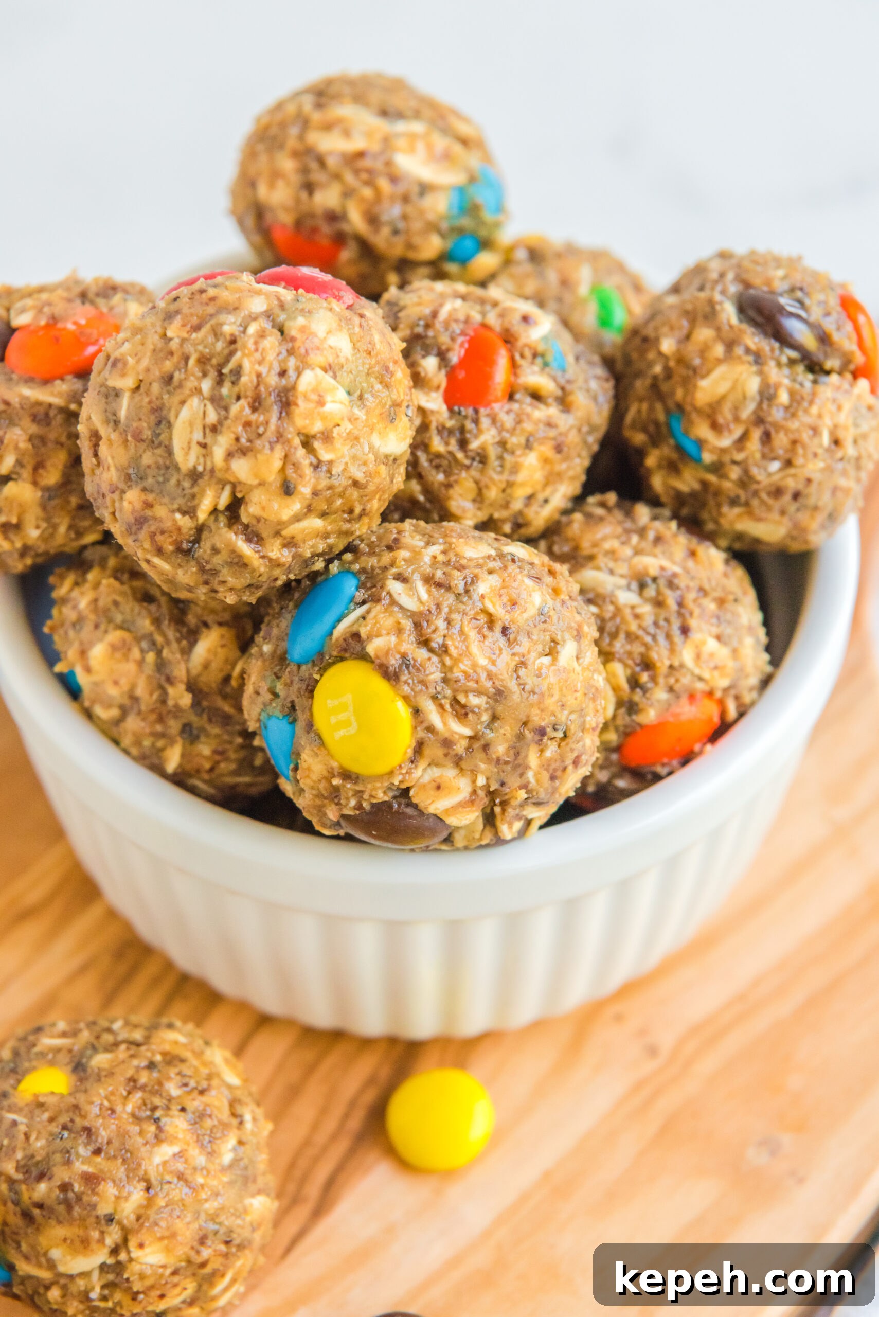 No-Bake M&M Energy Bites: Chocolate Peanut Butter Snack Balls 16 Close up view of No Bake M&M Energy balls in a white bowl.