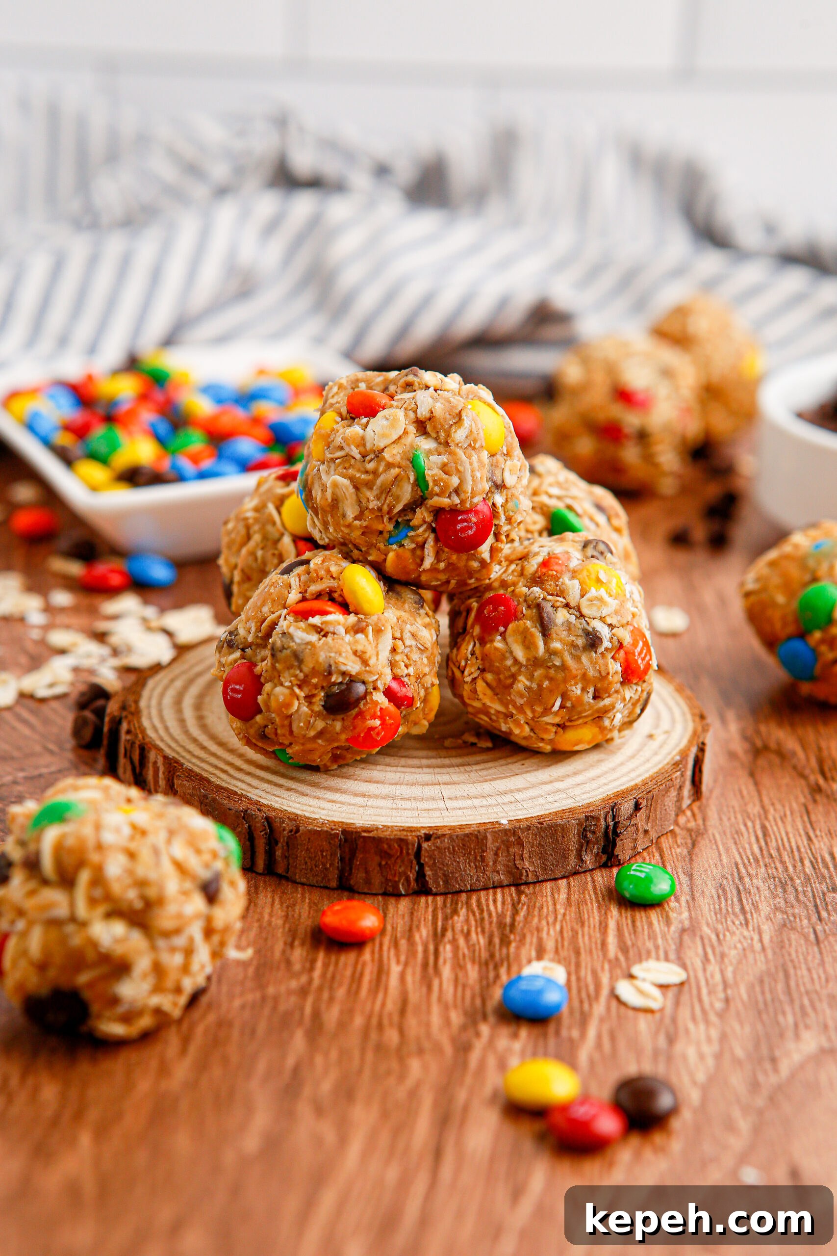 No-Bake M&M Energy Bites: Chocolate Peanut Butter Snack Balls 5 Close up view of No Bake M&M Energy balls on a wooden table