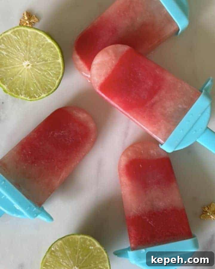 Refreshingly Tart Watermelon Lime Popsicles Recipe 2 Watermelon Popsicles on granite with limes